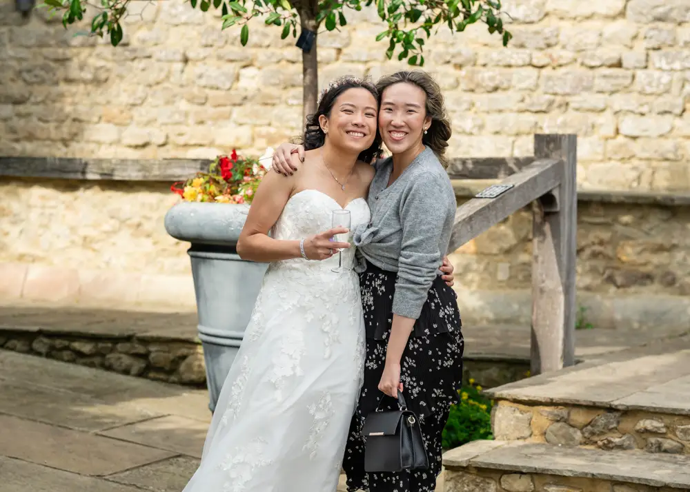 Notley Tythe Barn Wedding Photography. bride with girlfriend