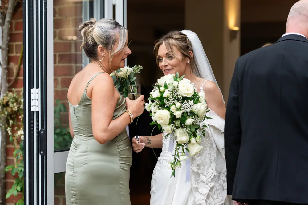 Stoke Place wedding photographer. Bride with guest.