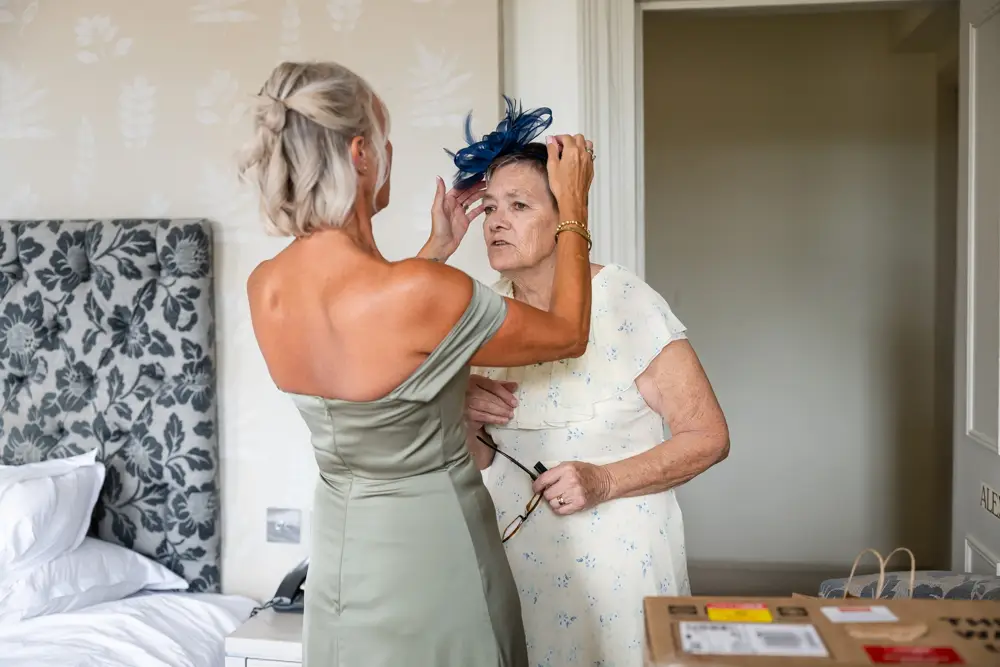 Stoke Place wedding photographer. Guests getting ready in Alexandra suite.