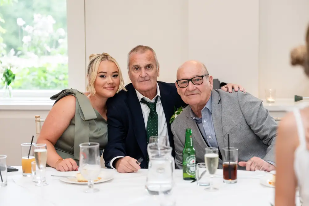 Stoke Place wedding photographer. family photo at table