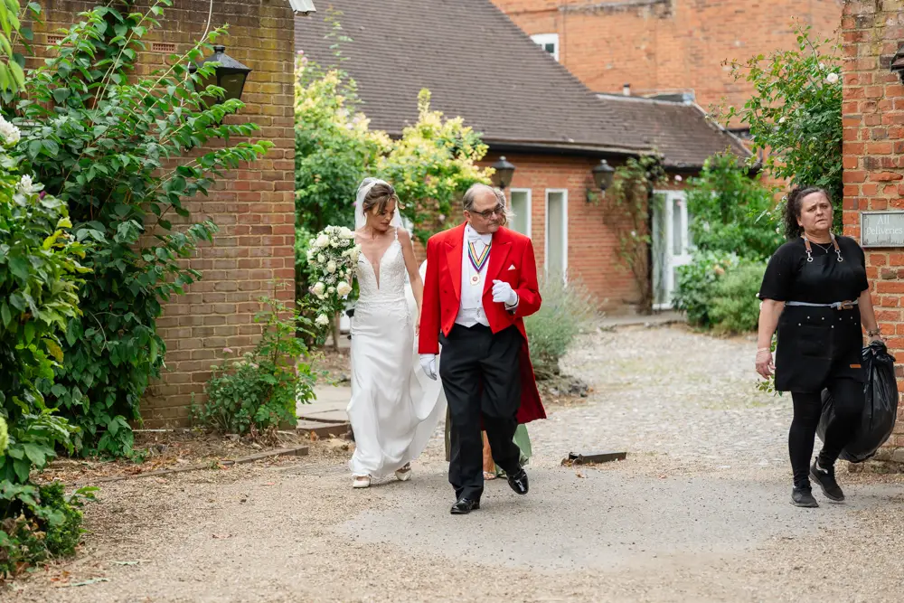 Stoke Place wedding photographer. Bride arriving for first look with father.