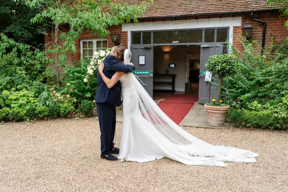 Stoke Place wedding photographer. Bride and father embrace