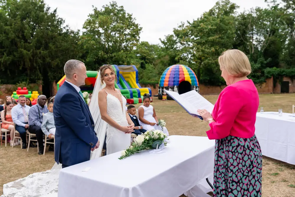 Stoke Place wedding photographer. Bride and groom during outdoor ceremony.