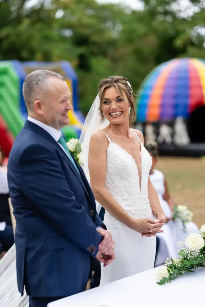 Stoke Place wedding photographer. Bride and groom during outdoor ceremony.