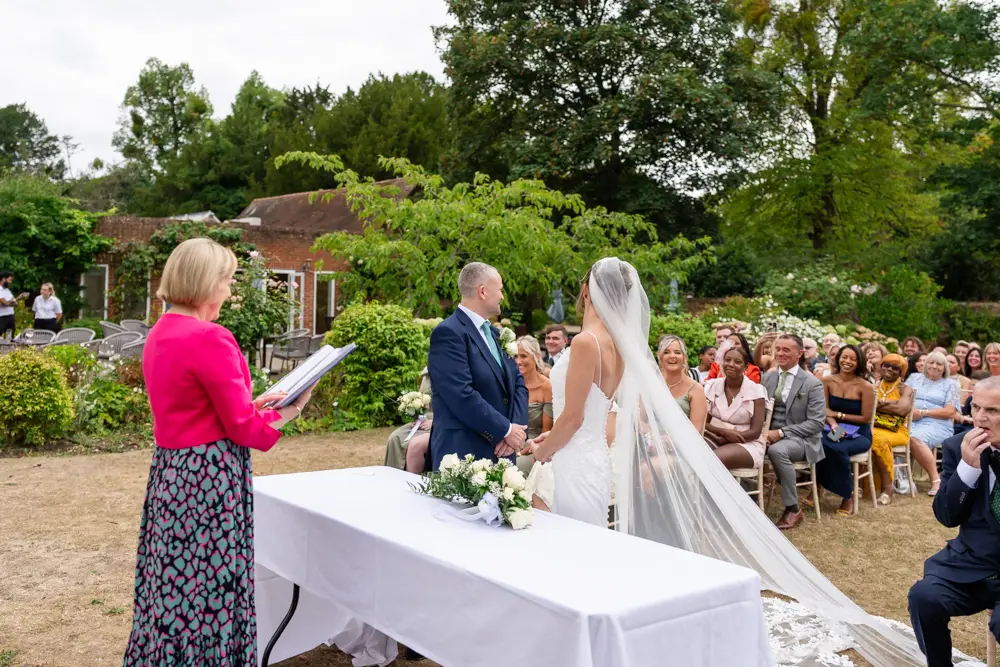 Stoke Place wedding photographer. Bride and groom during outdoor ceremony.
