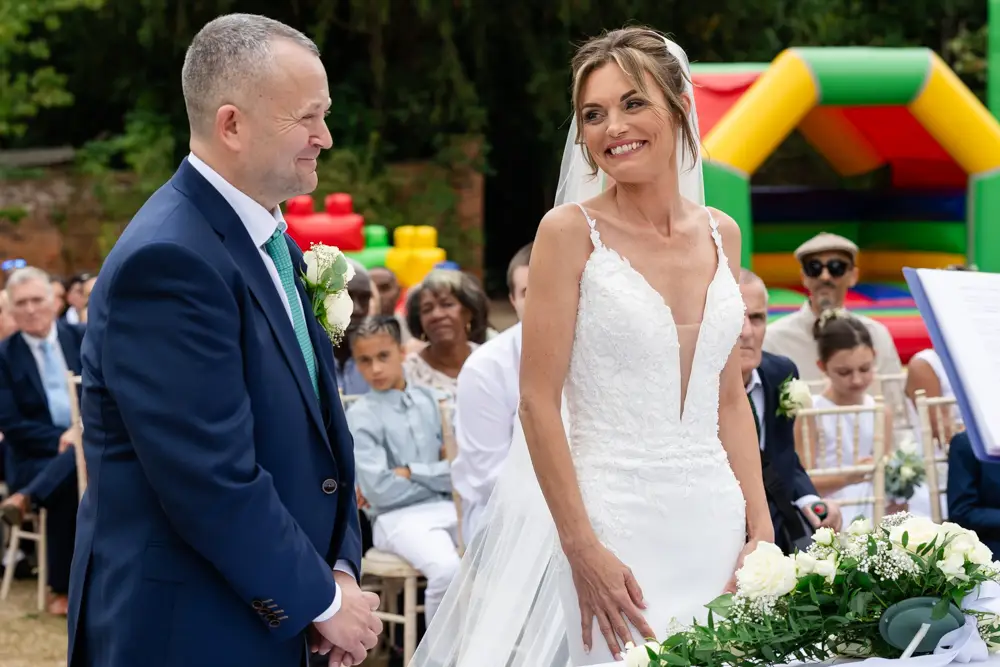 Stoke Place wedding photographer. Bride and groom during outdoor ceremony.