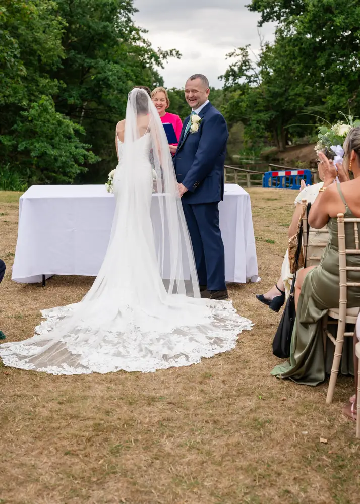 Stoke Place wedding photographer. Bride and groom during outdoor ceremony.
