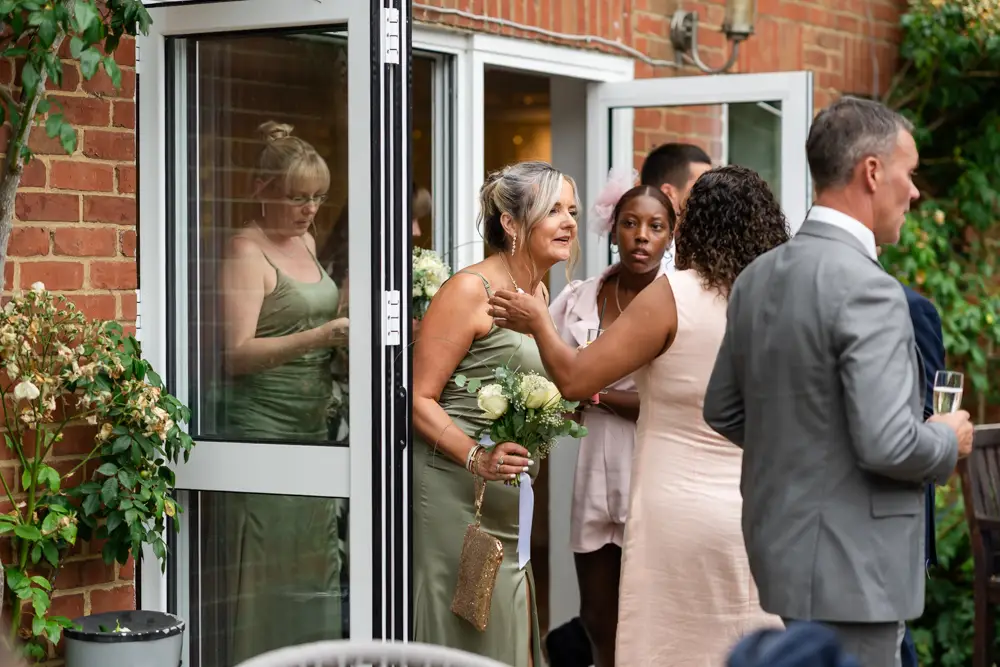 Stoke Place wedding photographer. Guests mingling.