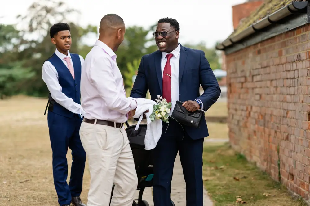 Stoke Place wedding photographer. Guests laughing.