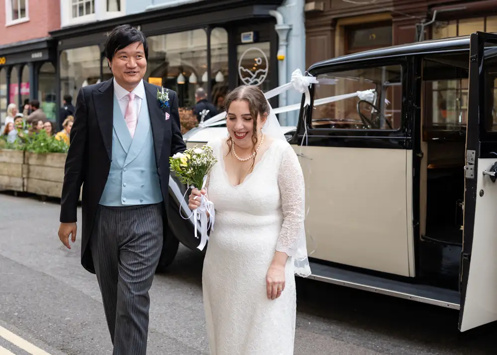 Lincoln College Oxford wedding photographer. Bride and groom arriving at the college having disembarked from their vintage rolls royce.