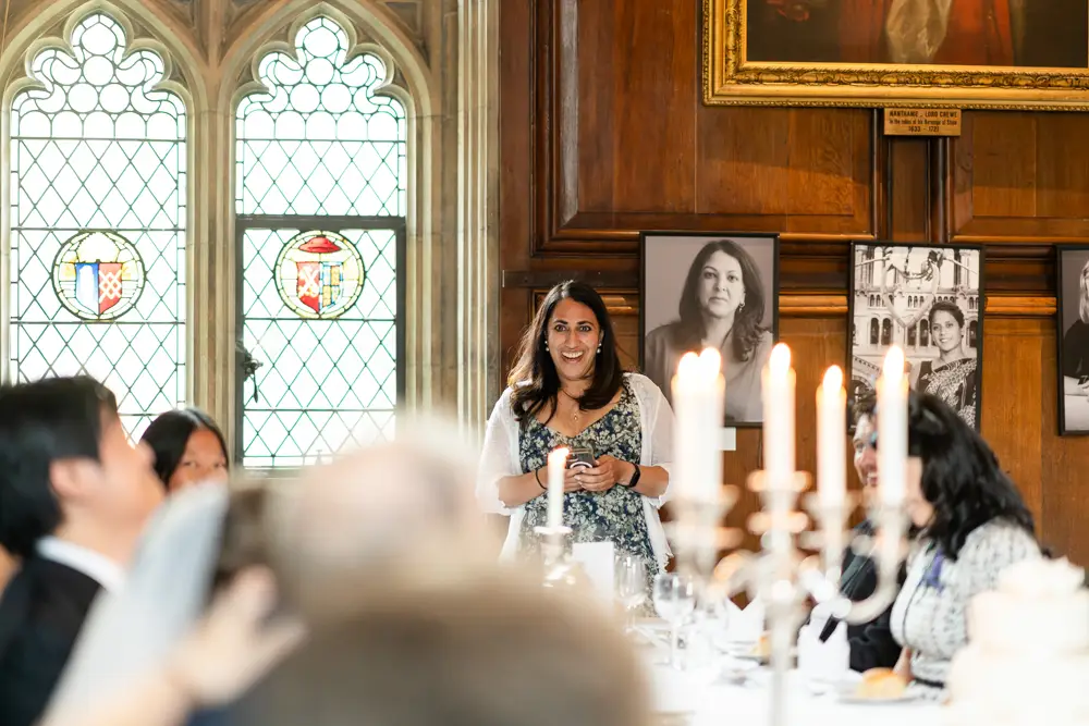 Lincoln College Oxford wedding photographer. Best woman speaks about the groom during wedding breakfast in the dining room.