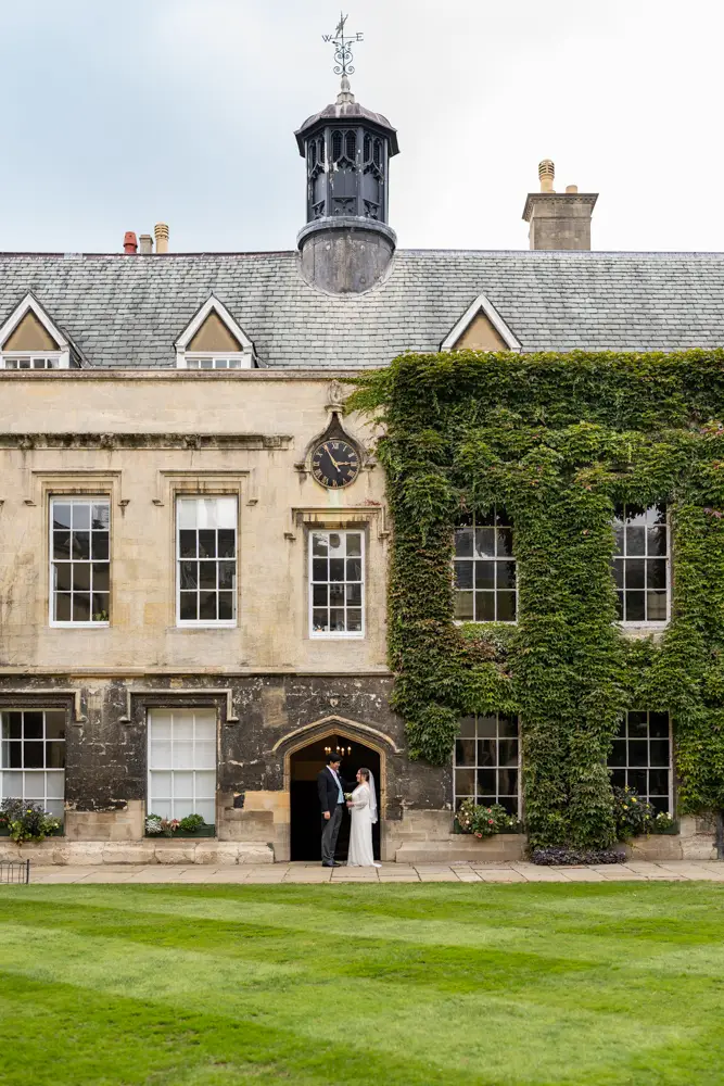 Lincoln College Oxford wedding photographer. Bride and groom under the clock tower in the front quad of the college.