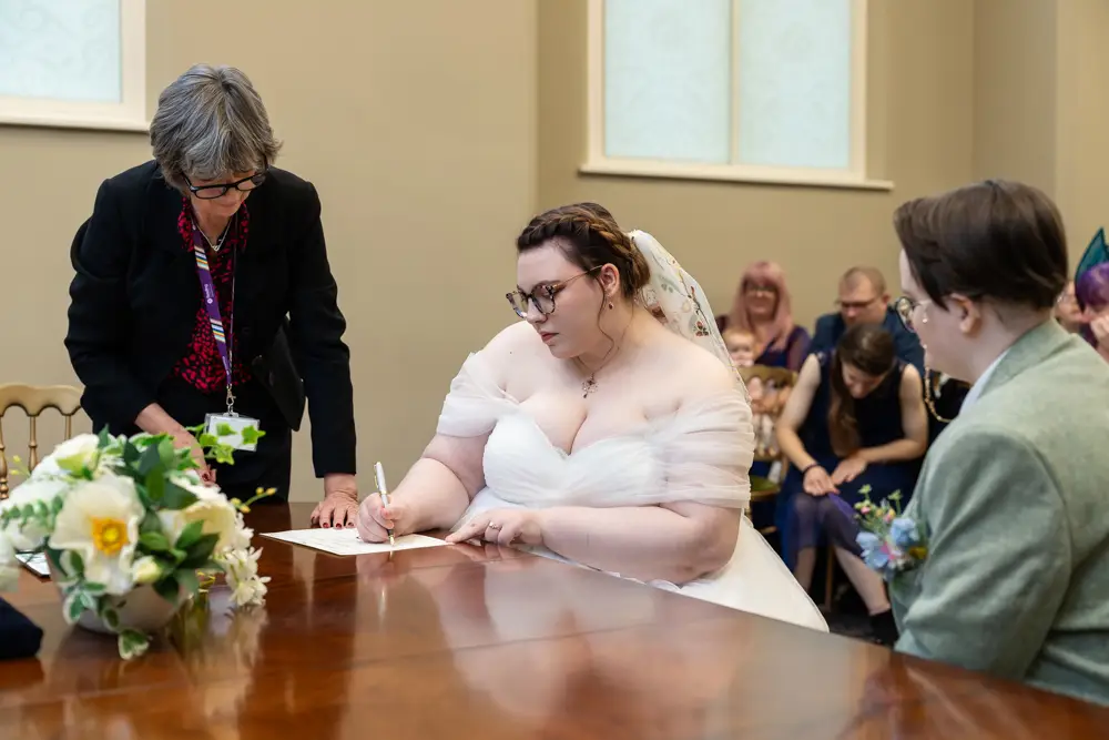 Reading Town Hall wedding photographer. Newlyweds signing register after ceremony at the town hall.
