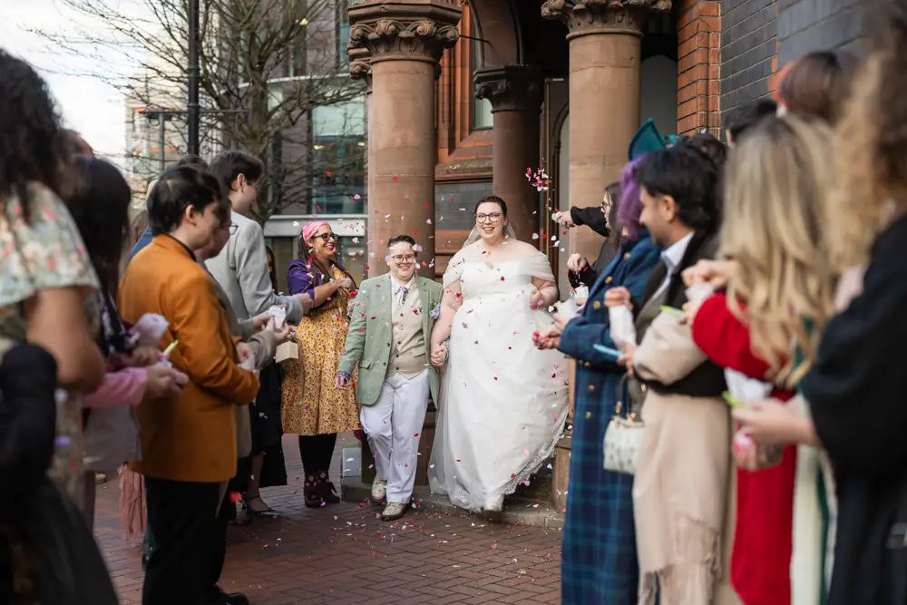 Reading Town Hall wedding photographer. Newlyweds in confetti tunnel outside the town hall.