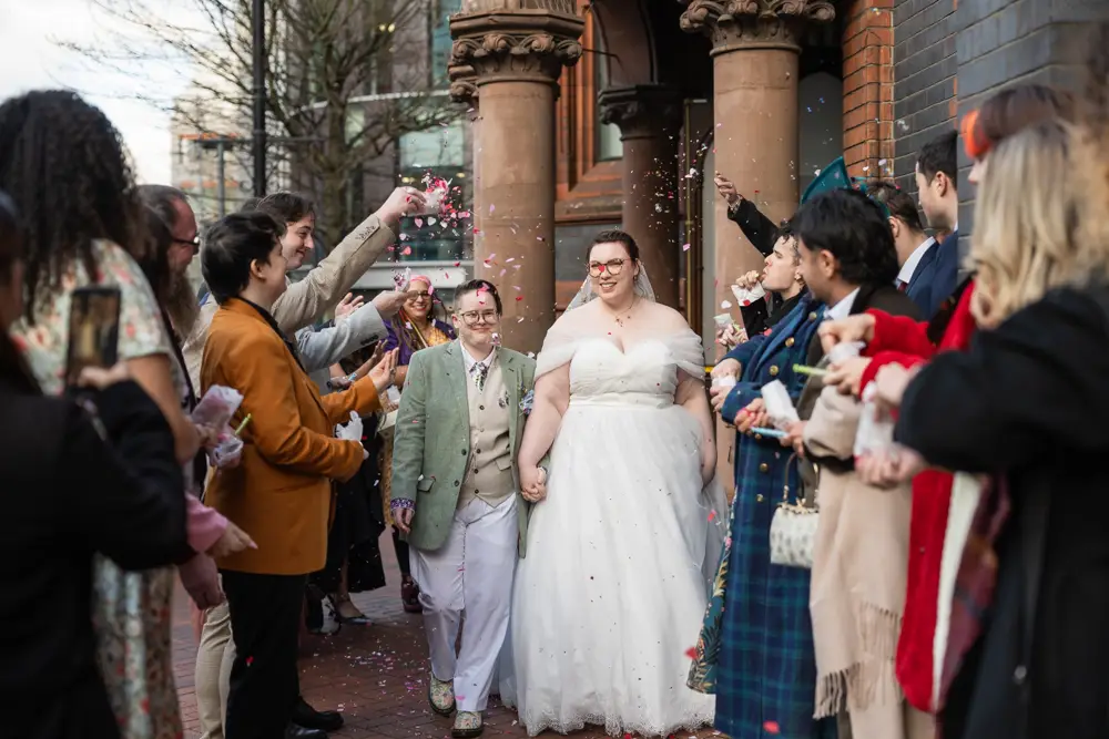 Reading Town Hall wedding photographer. Newlyweds in confetti tunnel outside the town hall.