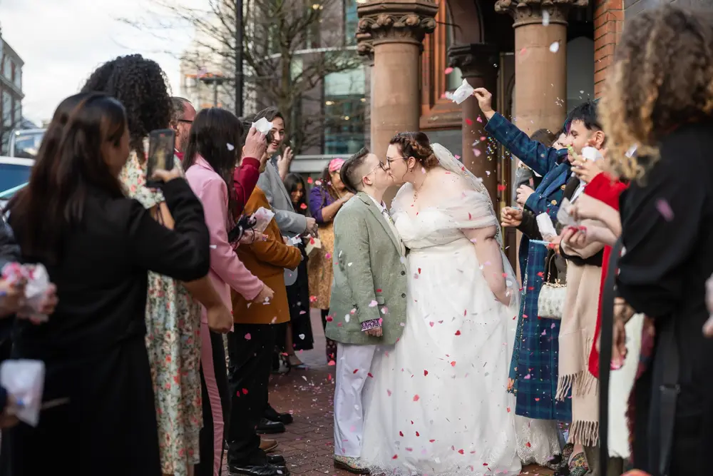 Reading Town Hall wedding photographer. Newlyweds in confetti tunnel outside the town hall.
