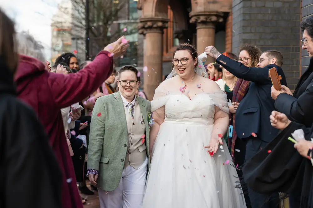 Reading Town Hall wedding photographer. Newlyweds in confetti tunnel outside the town hall.