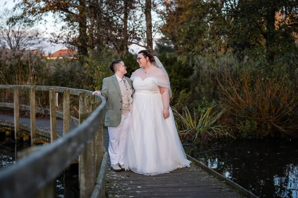 Same sex wedding photographer. Newlyweds in Woodford park after Reading town hall wedding.