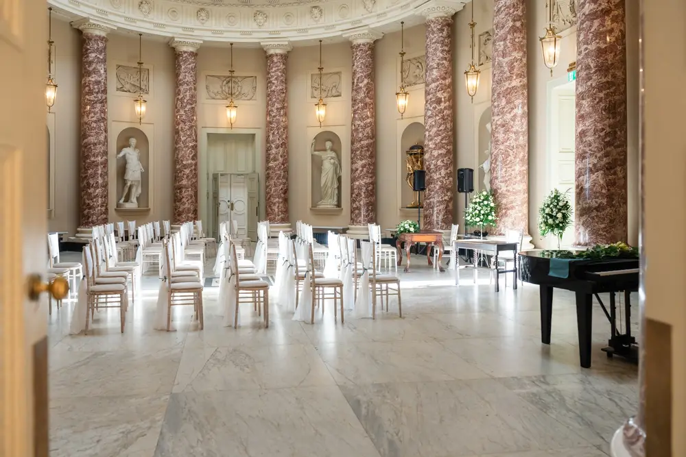 Stowe House wedding photographer. The marble hall set up for an elegant wedding ceremony