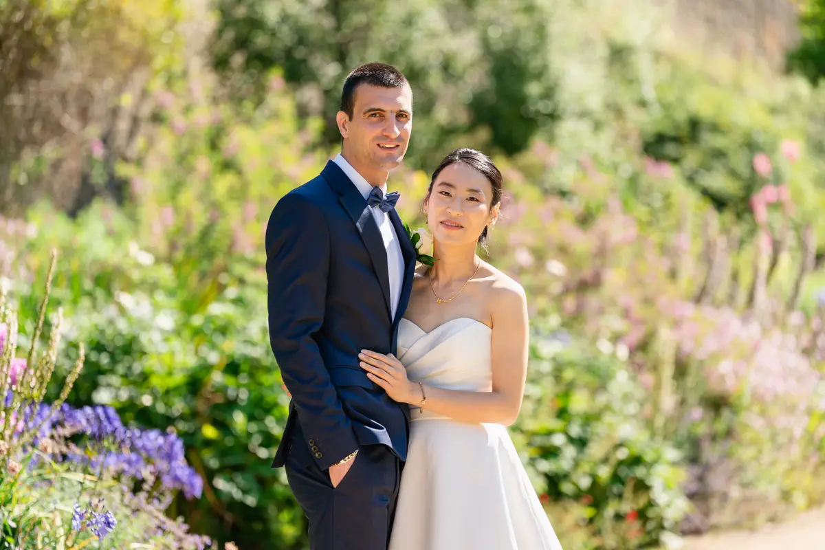 Bride and groom in gardens of New College. Oxford wedding photographer.