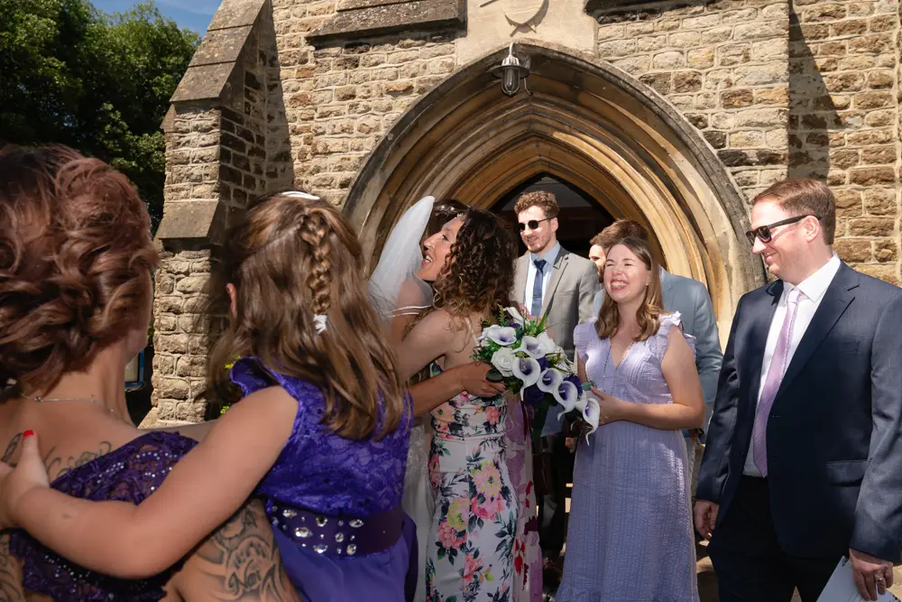 Oxfordshire Wedding Photographer. Guests outside Our Lady and St Edmund's church in Abingdon.