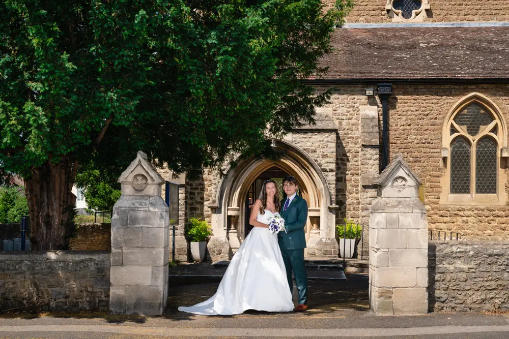 Oxfordshire Wedding Photographer. Bride and groom outside Our Lady and St Edmund's church in Abingdon.