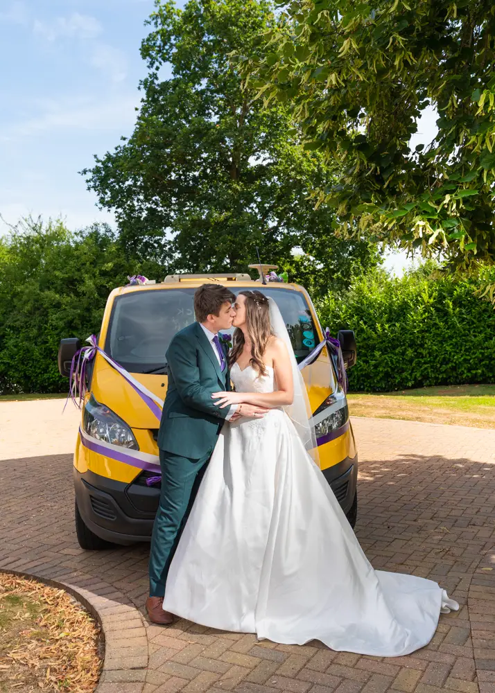 Oxfordshire Wedding Photographer. Bride and groom in front of wedding van at Dovecote Events.
