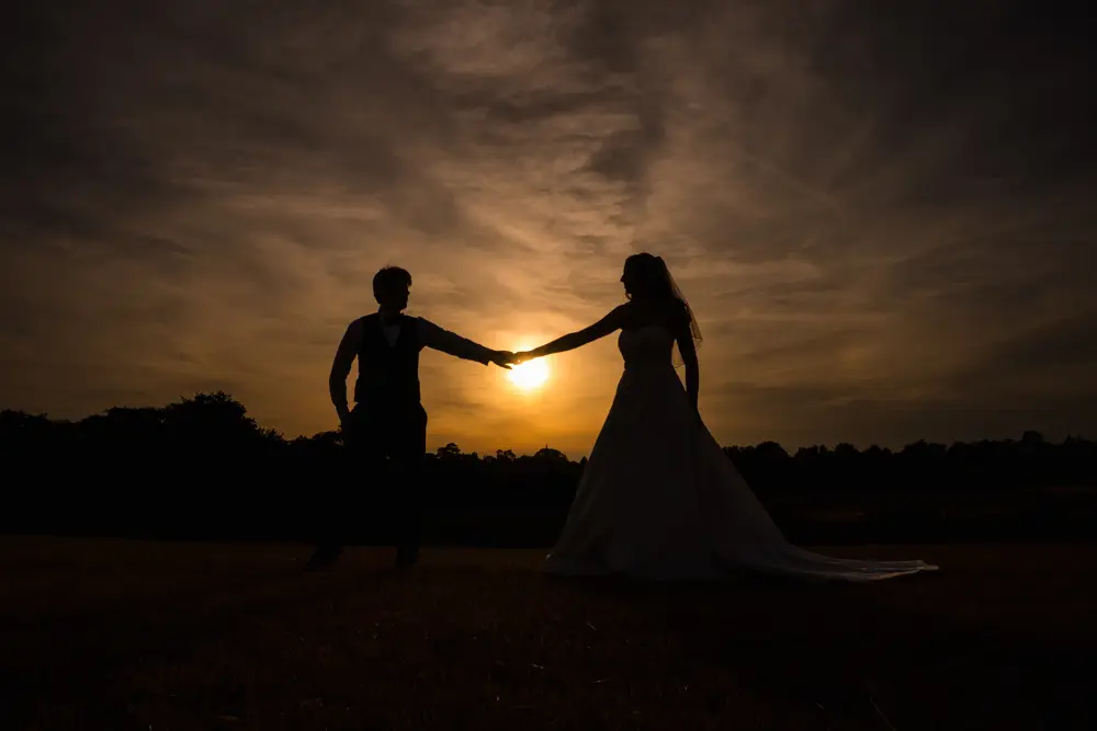 Oxfordshire Wedding Photographer. Bride and groom at sunset in field at Dovecote Events.