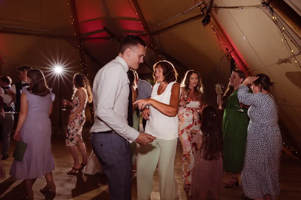 Oxfordshire Wedding Photographer. Guests dance at Dovecote Events.