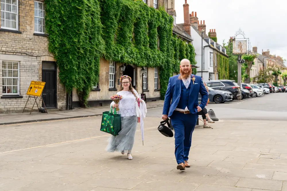 Bride and groom arriving for their wedding at Woodstock Town Hall in Oxfordshire.