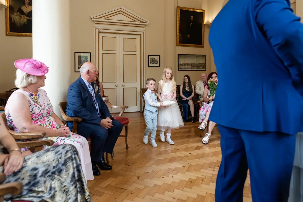 Young wedding guests bearing rings for ceremony at Woodstock Town Hall in Oxfordshire