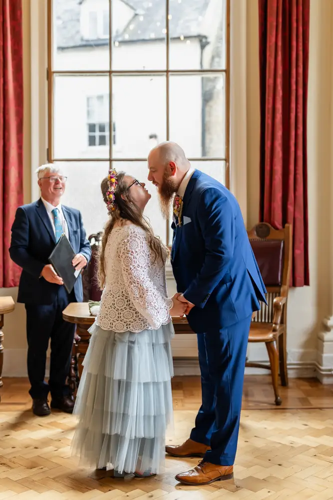 Bride and groom first kiss at Woodstock Town Hall in Oxfordshire