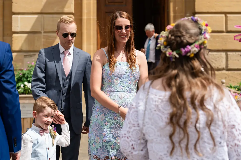 Bride greeting guests at her Woodstock Town Hall in Oxfordshire
