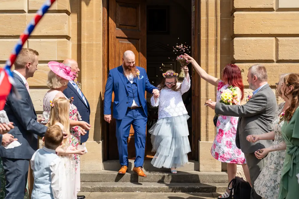 Bride and groom leaving Woodstock Town Hall in Oxfordshire