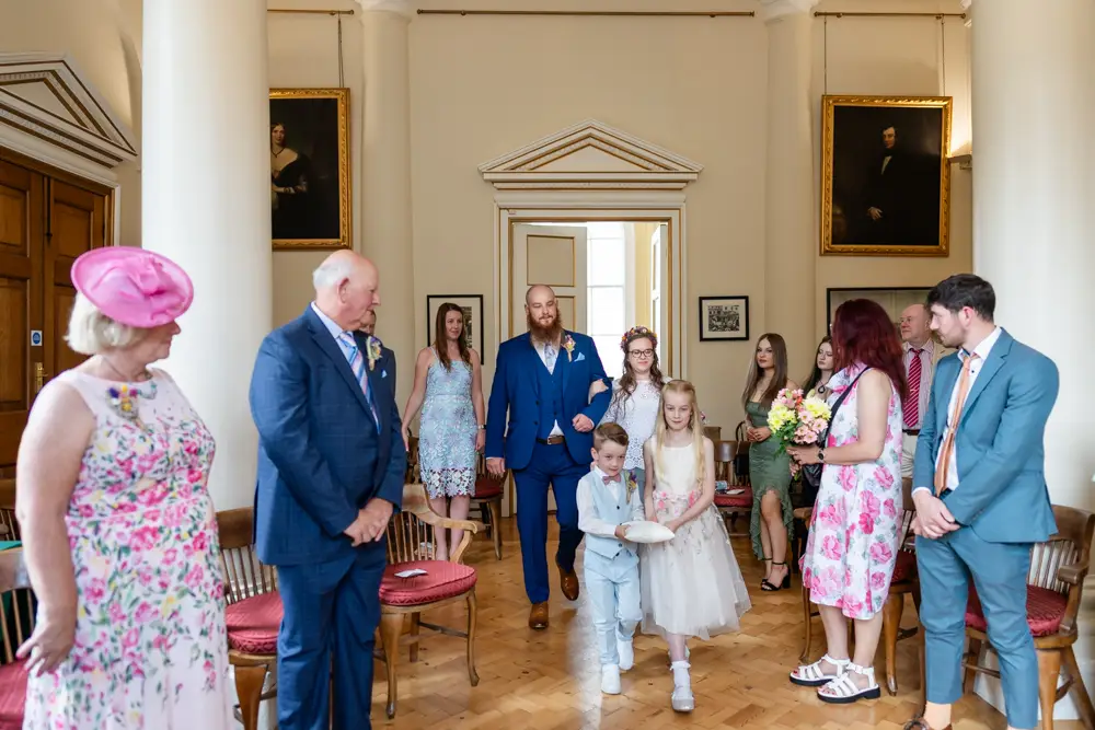 Bride and groom arriving in ceremony room at Woodstock Town Hall in Oxfordshire