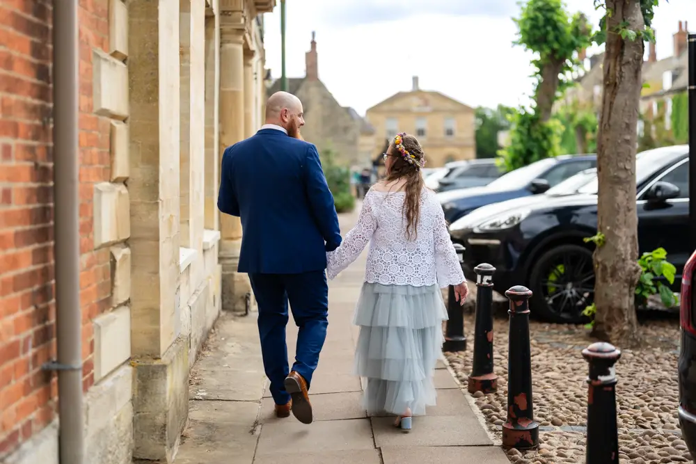 Woodstock wedding photographer. Bride and groom walk in the village after their wedding ceremony at Woodstock Town Hall in Oxfordshire.
