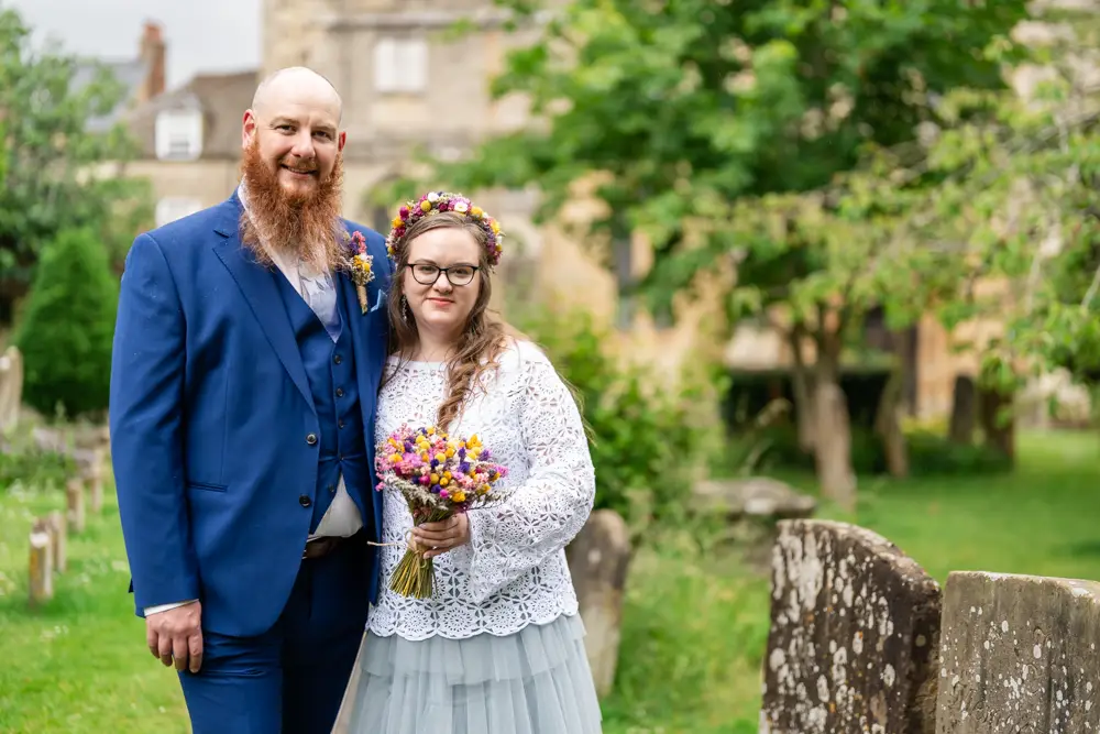 Woodstock wedding photographer. Bride and groom in church gardens in Oxfordshire.