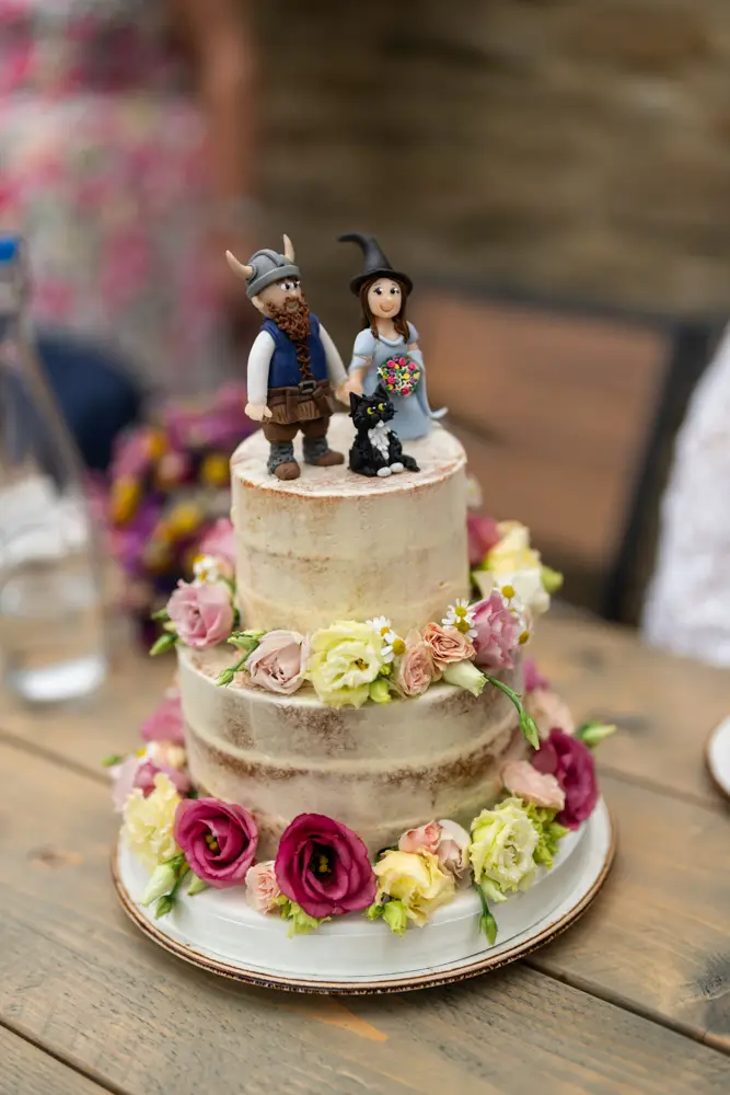 Woodstock wedding photographer. Wedding cake with viking, black cat and witch.