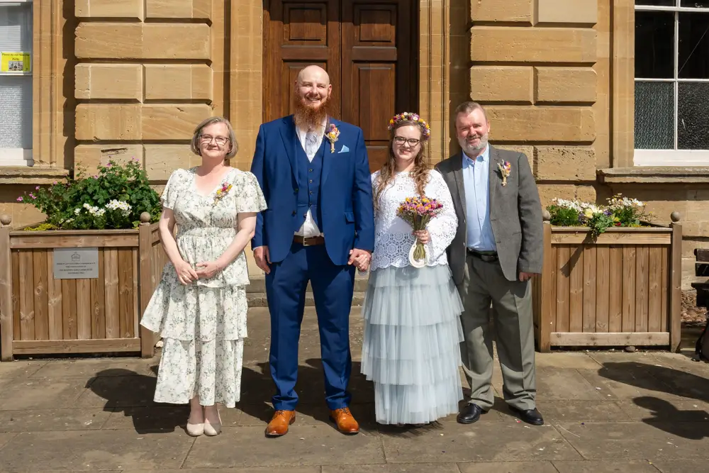 Bride and groom with family outside Woodstock Town Hall in Oxfordshire.