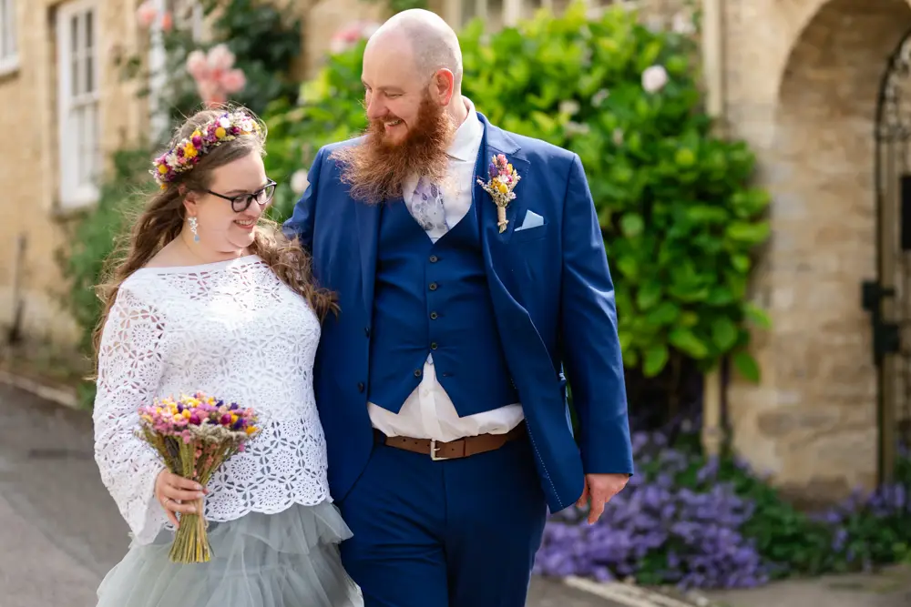 Woodstock wedding photographer. Bride and groom walk in the village after their wedding ceremony at Woodstock Town Hall in Oxfordshire.