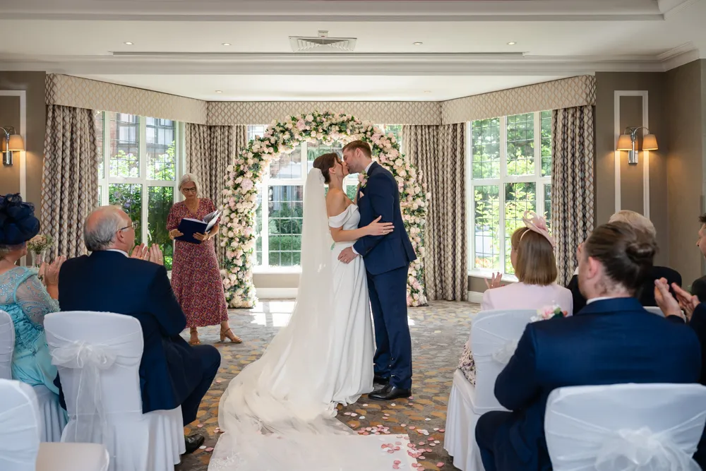 Bride and groom first kiss at the end of their Bull Hotel wedding ceremony.