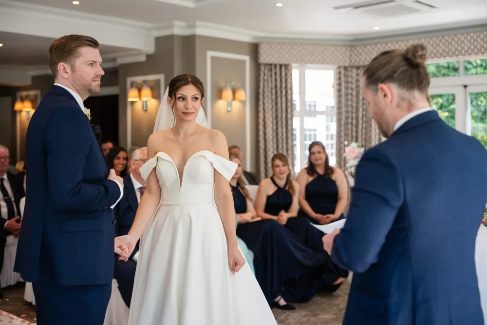 Bride and groom listen to reading during their Bull Hotel wedding ceremony.