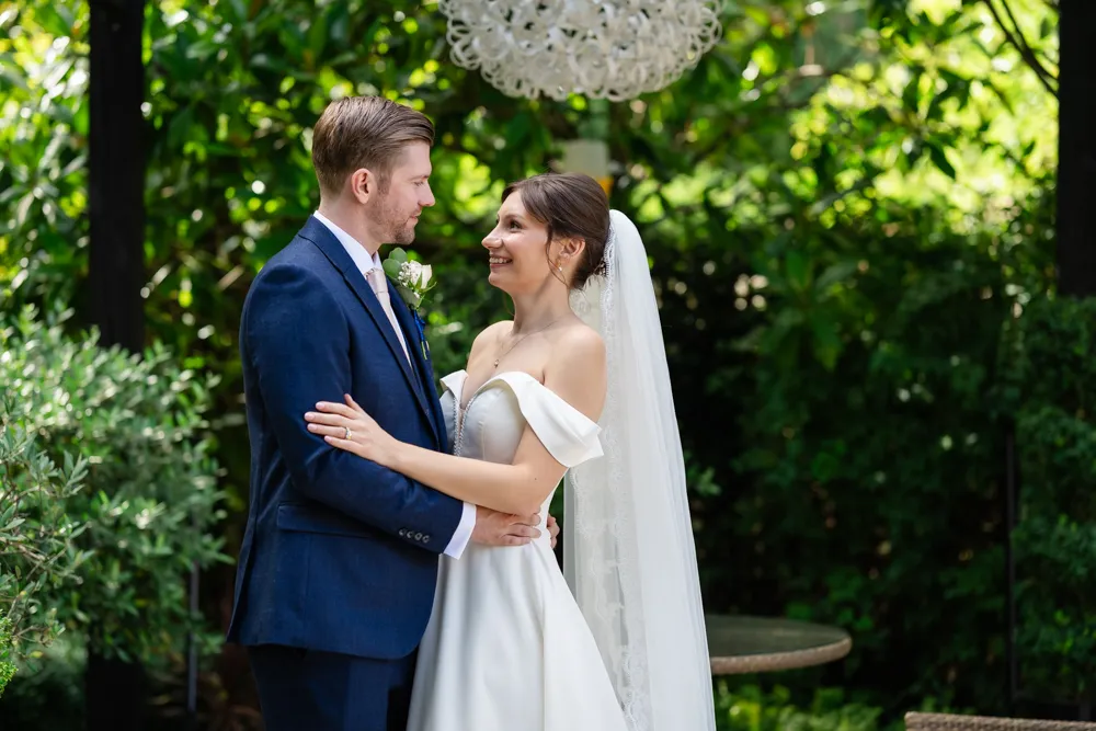 Bride and groom In the gardens of The Bull Hotel in Gerrards Cross on their August wedding day. Bull Hotel Wedding Photographer.