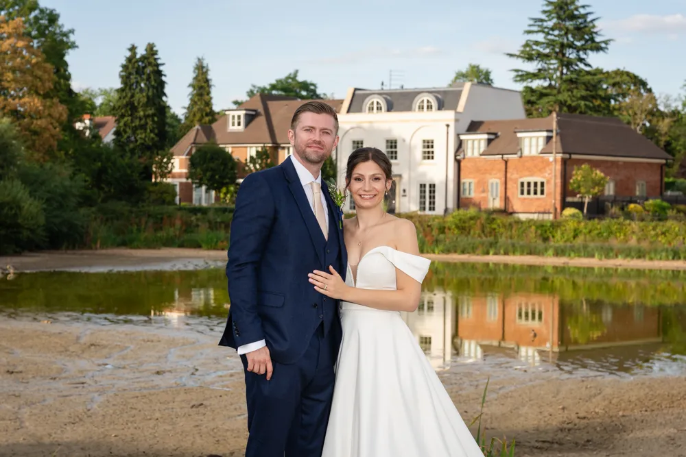 Bride and groom next to Latchmoor pond in Gerrards Cross. Bull Hotel Wedding Photographer.