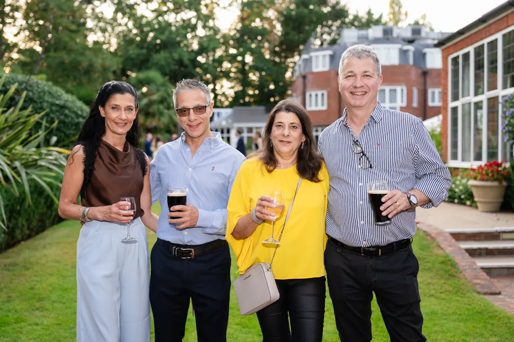 Guests in Bull Hotel gardens in Gerrards Cross. Bull Hotel Wedding Photographer.
