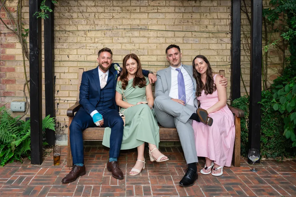 Guests in Bull Hotel gardens in Gerrards Cross. Bull Hotel Wedding Photographer.