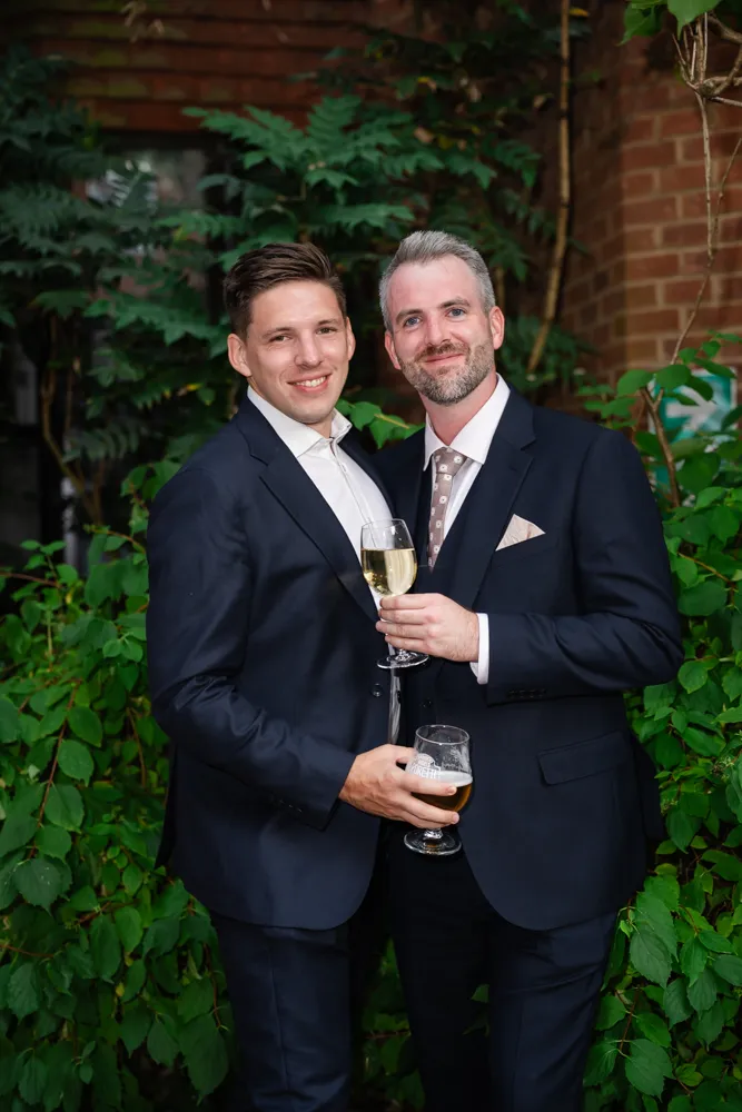 Guests in Bull Hotel gardens in Gerrards Cross. Bull Hotel Wedding Photographer.