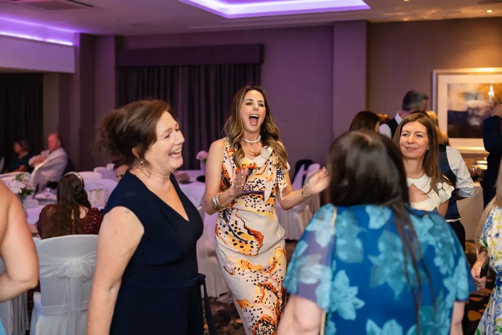 Guests dancing in Thames Suite. Bull Hotel Wedding Photographer.