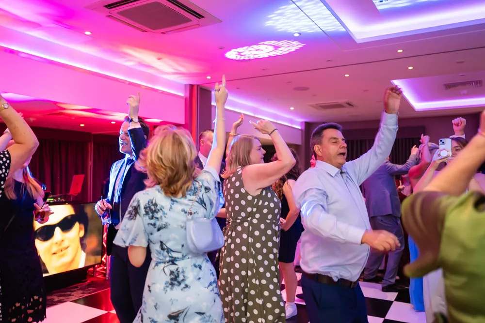 Guests dancing in Thames Suite. Bull Hotel Wedding Photographer.