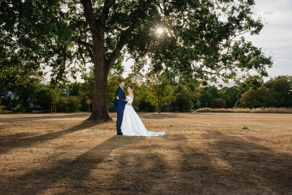 Bride and groom under a tree during golden hour. Bull Hotel Wedding Photographer.